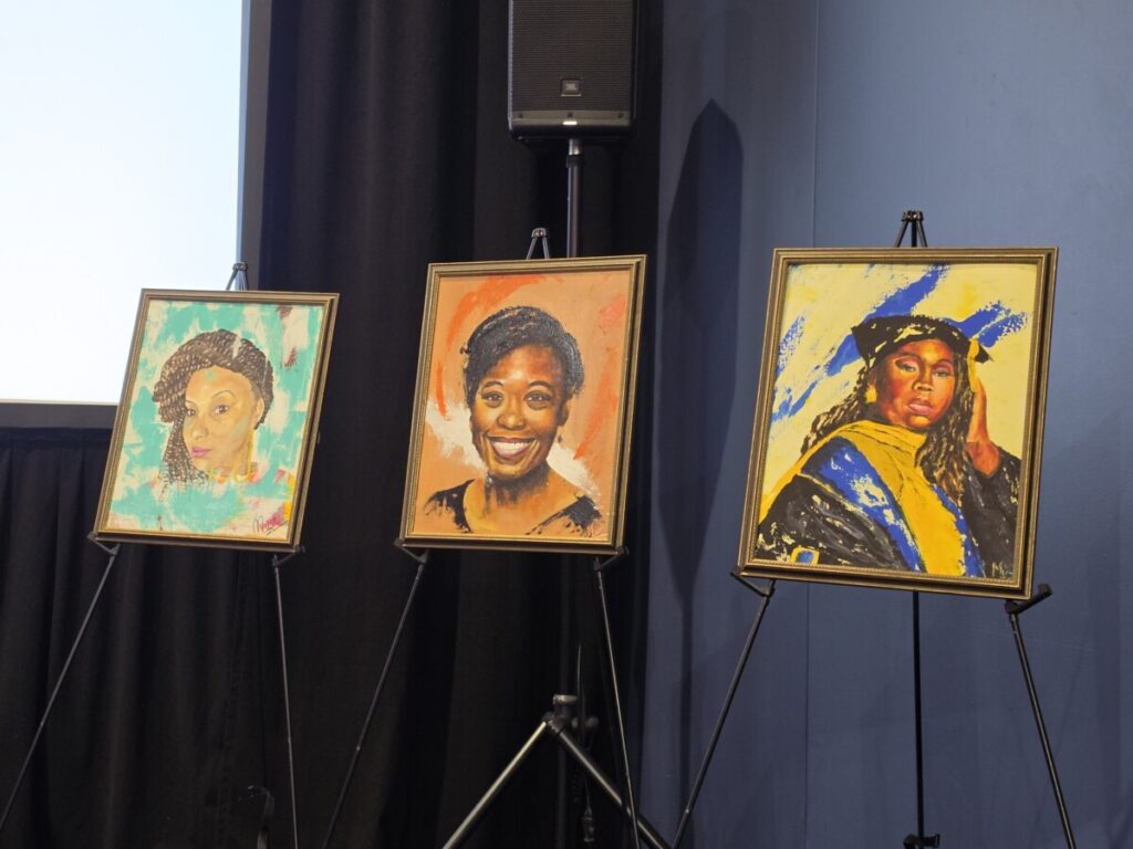Three of Omari Maynard’s paintings of women who died due to maternal health-related complications, featured during the “Beyond the Statistics: A Conversation on Black Fathers Protecting Black Motherhood” panel at the 55th Congressional Black Caucus Foundation’s Annual Legislative Conference on Sept. 17. (Photo: Myla S. Roundy/HU News Service)