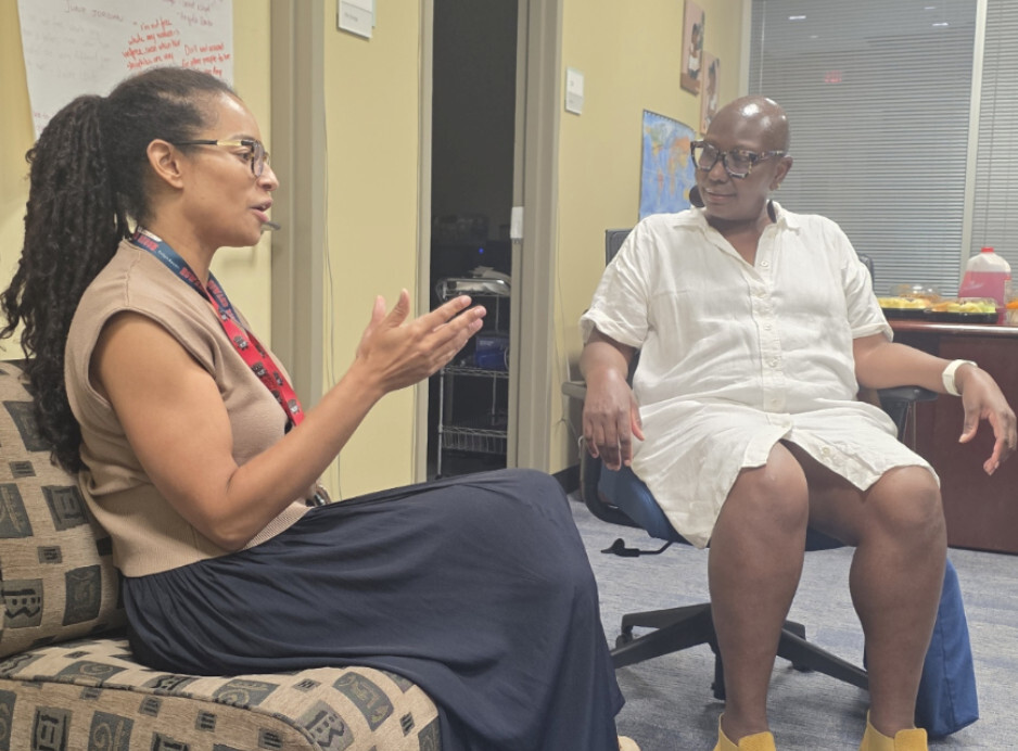 Dr. Anita Plummer speaking with colleagues at the Louis Stoke Health Sciences Library (by Israel Johnson)