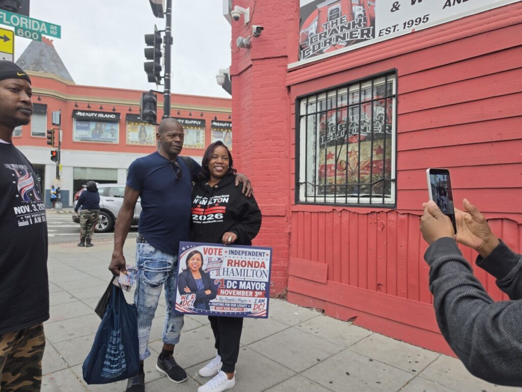On Oct. 10 in Ward 1, the independent candidate for D.C. mayor, Rhonda Hamilton, takes a photo with a D.C. voter. (Photo: Myla S. Roundy/HU News Service)