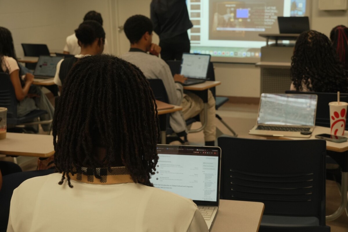 Students take notes in a global cultures and linguistics class. (Jadyn Hood/The Hilltop)